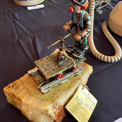 Ron Lee clown on pushcart on stone base