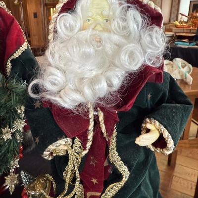 2 Christmas themed dressed up Santa figures