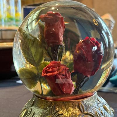 Rose in water glass crystal ball on stand