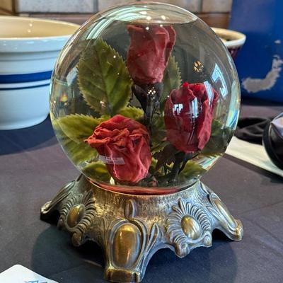 Rose in water glass crystal ball on stand