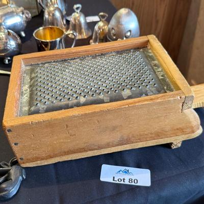 Vintage cheese grater attached to wood box