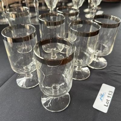 Set of 7 clear bar glasses w/silver chrome top rim