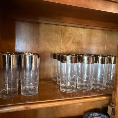 Top shelf of Vintage silver top rimmed Barware Glasses