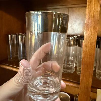 Top shelf of Vintage silver top rimmed Barware Glasses