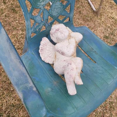 2 patio chairs, table, 2 angels and a cherub