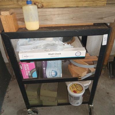 Black metal cart with contents
