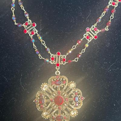 Gold toned red jeweled necklace with pendant