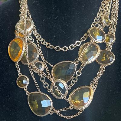 Gold toned stacked necklace with jewels