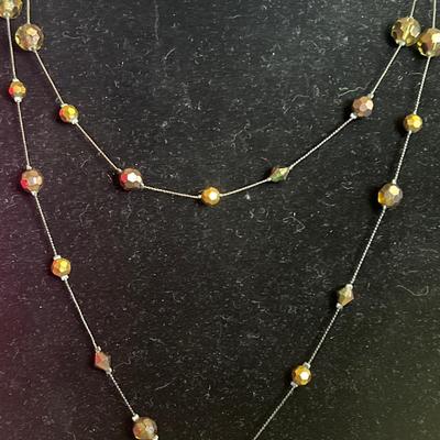 Long beaded brown toned necklace