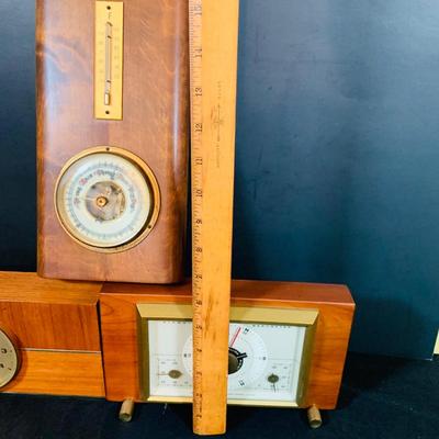 LOT 43: Collection of Wood Mounted Clock, Barometer and Thermometers Including Junghans Battery Desk Clock, Airguide Barometer, and More