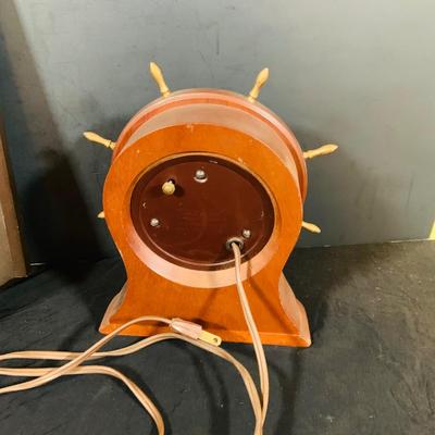 LOT 44 Seth Thomas Electric Ships Wheel Clock, a Park Sherman Cigarette Dispenser Ship’s Wheel Clock and a Versailles Barometer