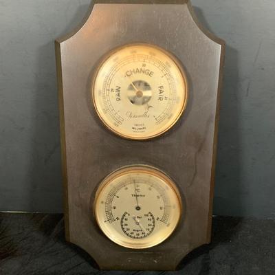 LOT 44 Seth Thomas Electric Ships Wheel Clock, a Park Sherman Cigarette Dispenser Ship’s Wheel Clock and a Versailles Barometer