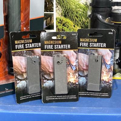 LOT 66: Bushnell Rechargeable Flashlight, CAT XL 9 in 1 Multi-Tool Set, National Geographic Binoculars and Three Magnesium Fire Starters...