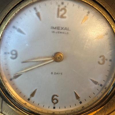 LOT 104: Vintage Imexal 18 Jewel 8-day World Clock, Florn Travel Alarm Clock, Bulova Swiss Made Alarm & Wooden Wall Barometer Made in...