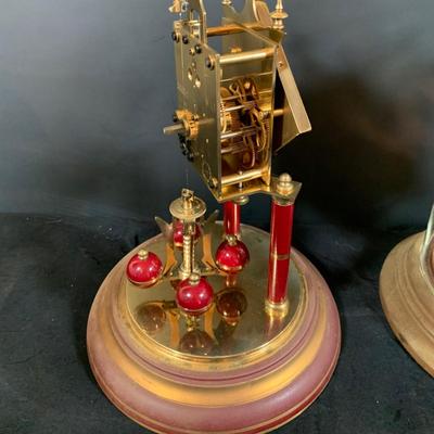 LOT 168; Collection of Two (2) Glass Domed Anniversary Clocks - Red Diamond Faced Clock by Schatz and Cooper Colored Clocky by...