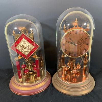 LOT 168; Collection of Two (2) Glass Domed Anniversary Clocks - Red Diamond Faced Clock by Schatz and Cooper Colored Clocky by...