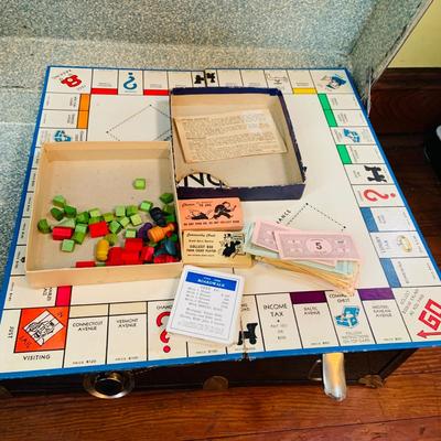 LOT 291: Black Steamer Trunk Loaded with Vintage Toys and Books Including Monopoly, Cribbage and More