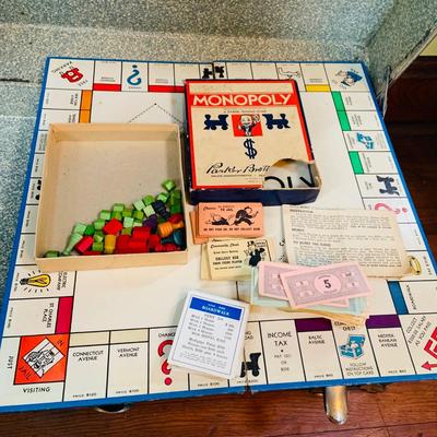 LOT 291: Black Steamer Trunk Loaded with Vintage Toys and Books Including Monopoly, Cribbage and More