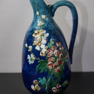 INTERESTING HAND CRAFTED POTTERY PITCHER OF HEAVY BLUE TONE GLAZE & HAND PAINTED FLORALS