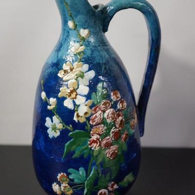 INTERESTING HAND CRAFTED POTTERY PITCHER OF HEAVY BLUE TONE GLAZE & HAND PAINTED FLORALS