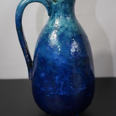 INTERESTING HAND CRAFTED POTTERY PITCHER OF HEAVY BLUE TONE GLAZE & HAND PAINTED FLORALS