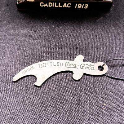1913 CADILLAC TABLE LIGHTER AND A COCA-COLA BOTTLE OPENER