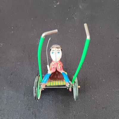 TIN ARMY STAFF CAR AND A JOCKEY IN A CART (WHO LOST HIS HORSE)