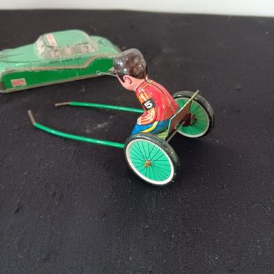 TIN ARMY STAFF CAR AND A JOCKEY IN A CART (WHO LOST HIS HORSE)