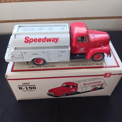 1957 INTERNATIONAL R-190 DIE-CAST FUEL TANKER AND THE TIN BODY OF A TOY CAR