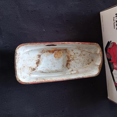 1957 INTERNATIONAL R-190 DIE-CAST FUEL TANKER AND THE TIN BODY OF A TOY CAR