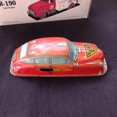 1957 INTERNATIONAL R-190 DIE-CAST FUEL TANKER AND THE TIN BODY OF A TOY CAR