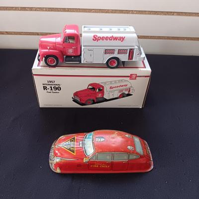 1957 INTERNATIONAL R-190 DIE-CAST FUEL TANKER AND THE TIN BODY OF A TOY CAR