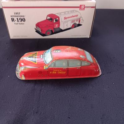 1957 INTERNATIONAL R-190 DIE-CAST FUEL TANKER AND THE TIN BODY OF A TOY CAR