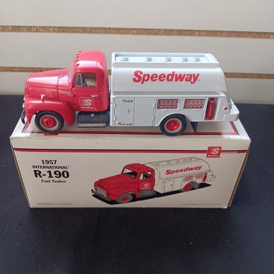 1957 INTERNATIONAL R-190 DIE-CAST FUEL TANKER AND THE TIN BODY OF A TOY CAR