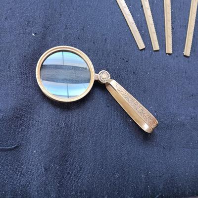2 TABLE LIGHTERS, LETTER OPENERS AND FOLDING BRASS MAGNIFYING GLASS