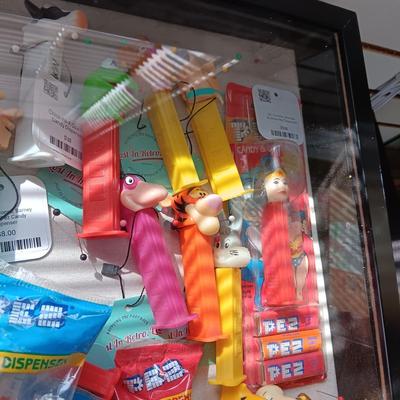 LOCKING GLASS FRONT DISPLAY CASE FULL OF PEZ DISPENSERS