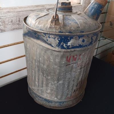 OLD GAS CAN AND A FIRE CHIEF GAS PRICE SIGN