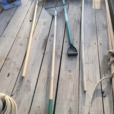 2 rakes, snow shovel and broom