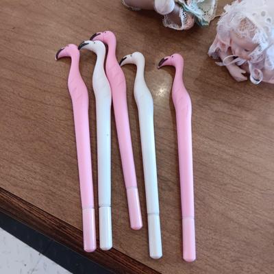2 SMALL PORCELAIN BABIES AND 5 FLAMINGO WRITING PENS