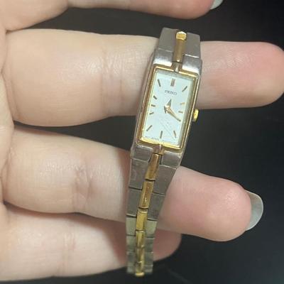 Silver toned watch band and random watch faces