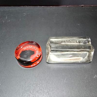 Vintage glass Madeira Hill & Co. paperweight and an Advertising Trade Adairack Mark Glass paperweight
