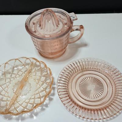 Pink depression glass divided dish, platter, and Juice reamer with measuring glass cup