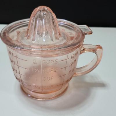 Pink depression glass divided dish, platter, and Juice reamer with measuring glass cup