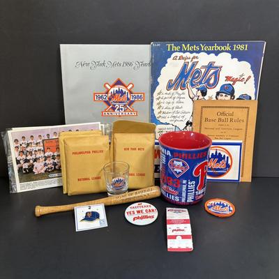 LOT 94: Mets & Phillies Collection: Yearbooks, Ticket Stub, Mug, Vintage Rule Book along with APBA Game Card Packets