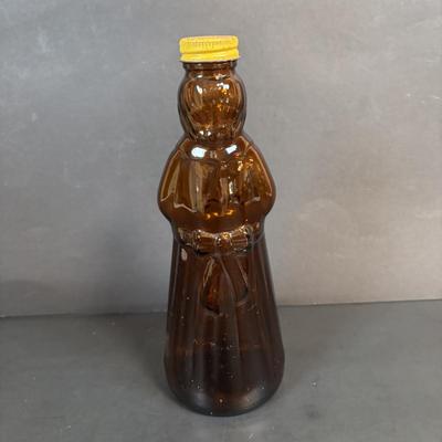 LOT 105: Vintage Kitchen: Mrs. Butterworth Syrup Bottle, Kitchen Prayer Plate, Tins, Atlas Canning Jar & Ceramic Bear Honey Pot