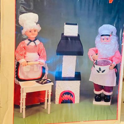 LOT 254: Animatronic Santa and Mrs Claus Baking Cookies Including Table and Lighted Oven In Original Box