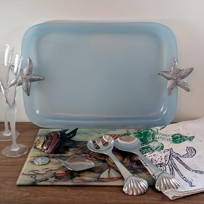 LOT 55K: Beach Themed Collection, 2 Fluted Champagne Glasses, Serving Tray, Utensils, Glass Cutting Board, Kitchen Towels And Whimsical...