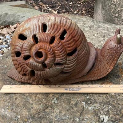 LOT 124G: Cast Iron Snail, Three Tier Folding Plant Stand and Concrete Sun Face Plaque