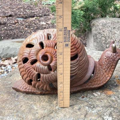 LOT 124G: Cast Iron Snail, Three Tier Folding Plant Stand and Concrete Sun Face Plaque