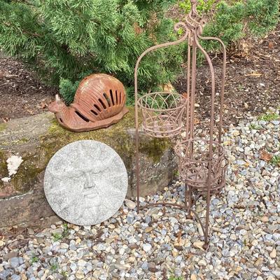 LOT 124G: Cast Iron Snail, Three Tier Folding Plant Stand and Concrete Sun Face Plaque